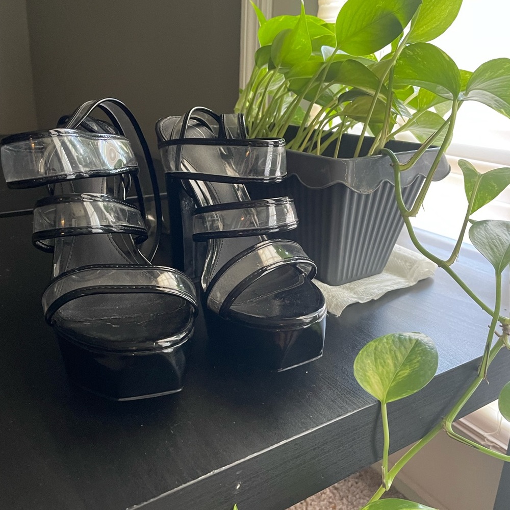 Black clear strapped platform heels.